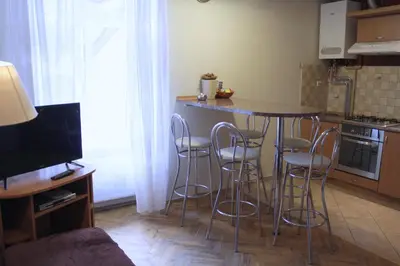 a kitchen with a table and stools in a room at 4Party in Kraków