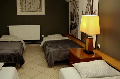 a hotel room with two beds and a lamp at 4Party in Kraków
