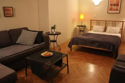 a living room with a couch and a bed at 4Party in Kraków