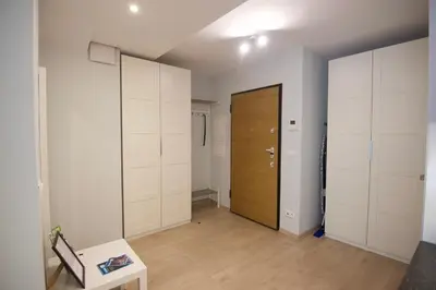 a room with white closets and a wooden door at Kraków Apartments - Solna Studio & Apartments in Kraków