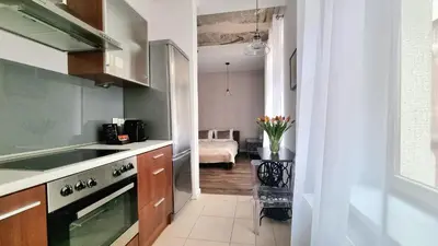 a kitchen with a sink and a stove top oven at NOOK NOOK Apartments Katarzyny 2 in Kraków