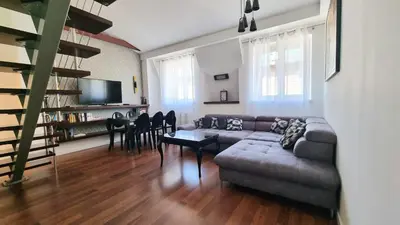 a living room with a couch and a table at NOOK NOOK Apartments Katarzyny 2 in Kraków