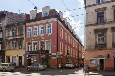 a building on the corner of a street with cars at NOOK NOOK Apartments Katarzyny 2 in Kraków
