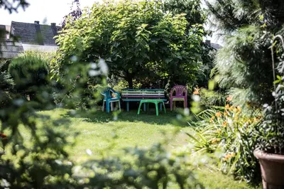 a garden with a table and chairs in the grass at Apartamenty na Kasztelańskiej in Spytkowice