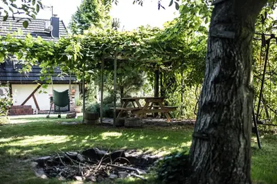 a picnic table in a yard with a tree at Apartamenty na Kasztelańskiej in Spytkowice