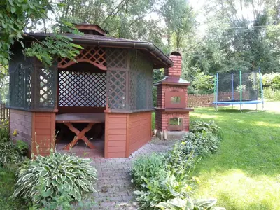 a large bird house in a garden at Agroturystyka Zagroda in Podobin