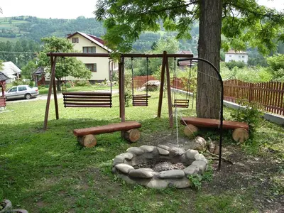 a park with a fire pit and a tree at Agroturystyka Zagroda in Podobin