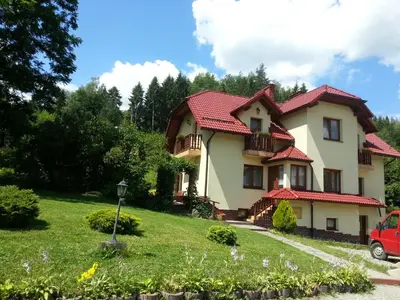a house with a red roof at Agroturystyka Zagroda in Podobin