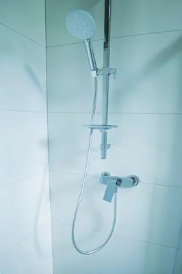 a shower with a shower head in a bathroom at Jałowcówka Centrum Aktywności Psychoruchowej in Koszarawa