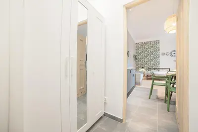 a hallway with a door leading to a dining room at Dizzy Daisy Downtown Apartments in Kraków