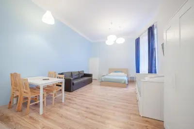 a living room with a table and a couch at Dizzy Daisy Downtown Apartments in Kraków