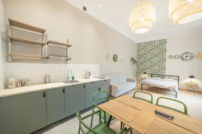 a kitchen with a table and a dining room at Dizzy Daisy Downtown Apartments in Kraków