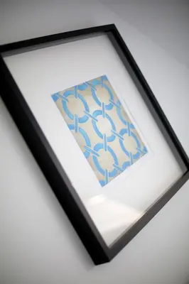 a picture of a picture frame with a painting of flowers at Pure Apartments Kraków in Kraków