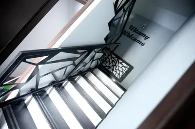 a stairwell in a building with a window at Pure Apartments Kraków in Kraków