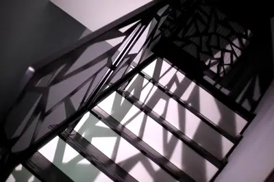 a window with its shadows on a wall at Pure Apartments Kraków in Kraków