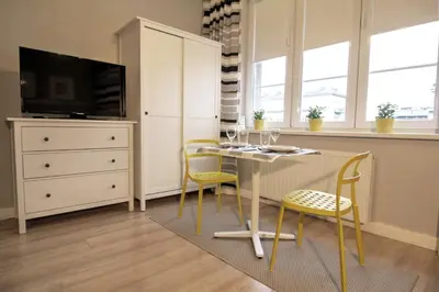 a dining room with a table and two chairs at Apartment I GrayFor2 Old Town Kraków in Kraków