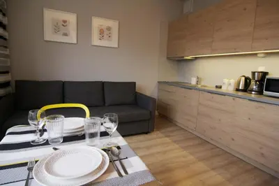 a dining table with a yellow chair in a kitchen at Apartment I GrayFor2 Old Town Kraków in Kraków