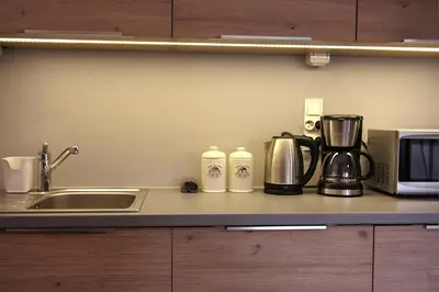 a kitchen counter with a coffee maker and a microwave at Apartment I GrayFor2 Old Town Kraków in Kraków