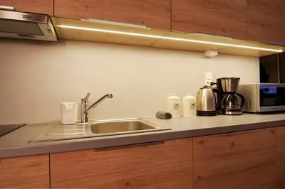 a kitchen counter with a sink and a microwave at Apartment I GrayFor2 Old Town Kraków in Kraków
