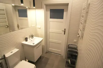 a bathroom with a sink and a toilet and a mirror at Apartment I GrayFor2 Old Town Kraków in Kraków