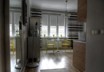 a kitchen with a table and yellow chairs in a room at Apartment I GrayFor2 Old Town Kraków in Kraków
