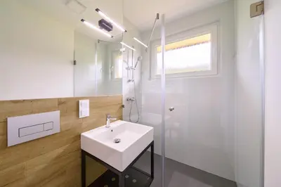 a white bathroom with a sink and a shower at RABKA ZDRÓJ Cegielski - pokoje wyremontowane in Rabka