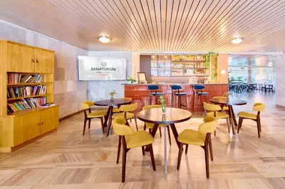 a restaurant with tables and chairs and a bar at RABKA ZDRÓJ Cegielski - pokoje wyremontowane in Rabka