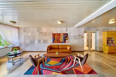 a living room with a couch and a table and chairs at RABKA ZDRÓJ Cegielski - pokoje wyremontowane in Rabka