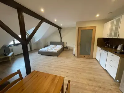 a living room with a table and a couch at Apartamenty w Rynku in Rabka