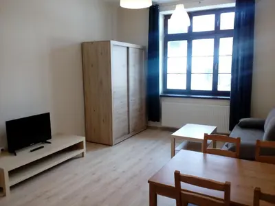 a kitchen and dining room with a table and chairs at Apartamenty w Rynku in Rabka
