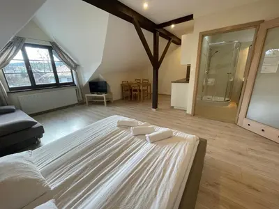 a bedroom with a bed and a table and a desk at Apartamenty w Rynku in Rabka