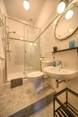 a bathroom with a toilet and a sink and a shower at Pokoje gościnne 