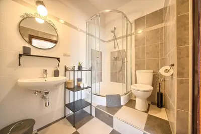 a bathroom with a shower and a toilet and a sink at Pokoje gościnne 