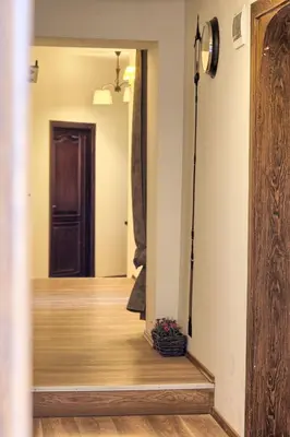 a hallway with a wooden floor and a mirror at Pokoje gościnne 