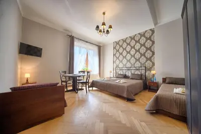 a bedroom with a bed and a table and a couch at Pokoje gościnne 