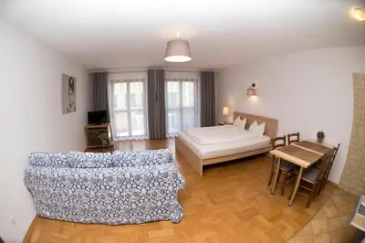 a living room with a bed and a table at Villa Verona in Kraków