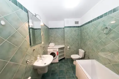 a bathroom with a sink and a toilet and a tub at Villa Verona in Kraków