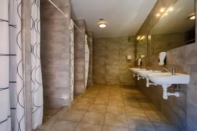 a bathroom with three sinks and two mirrors at Wioska Indiańska River Park Zator SPA RESORT in Zator