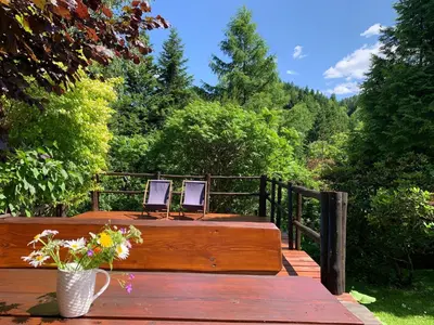 two chairs sitting on top of a wooden deck at Dom w górach in Zawoja