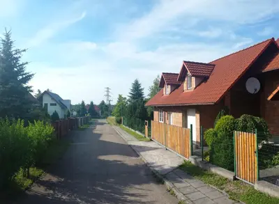 a house with a red roof on a street at Willa Elżbieta in Kraków