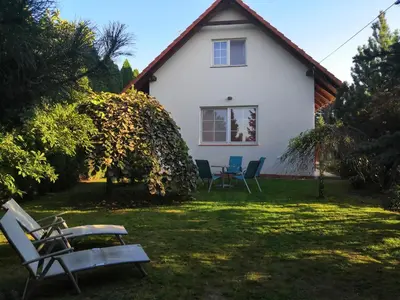 a house with chairs and a table in the yard at Willa Elżbieta in Kraków