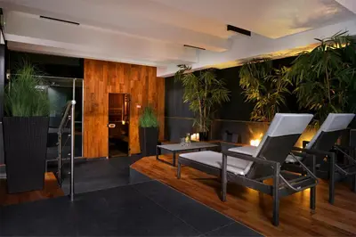 a living room with plants and a table and chairs at Hotel Kossak in Kraków