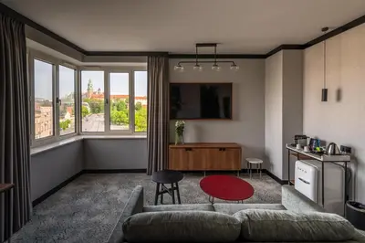 a living room with a couch and a red table at Hotel Kossak in Kraków