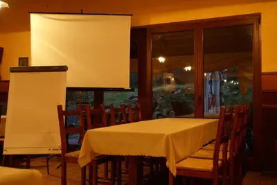 a bar in a restaurant with tables and chairs at Hotel Twardowski in Głogoczów