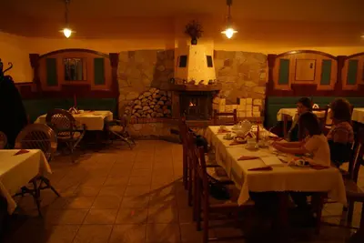 a dining room with a table and chairs and a window at Hotel Twardowski in Głogoczów