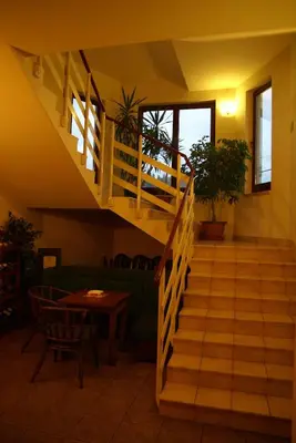 a staircase in a living room with a couch and a table at Hotel Twardowski in Głogoczów