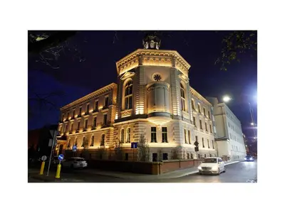 a large white building with a car parked in front of it at Premium Apartments by Wawel Castle in Kraków