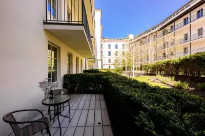 a balcony with a table and chairs in a building at Premium Apartments by Wawel Castle in Kraków
