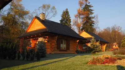 a log cabin with a cat on the roof at Chata w Rabce - Bajkowa Osada in Rabka