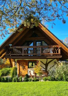 a house with a large deck on the front of it at Chata w Rabce - Bajkowa Osada in Rabka